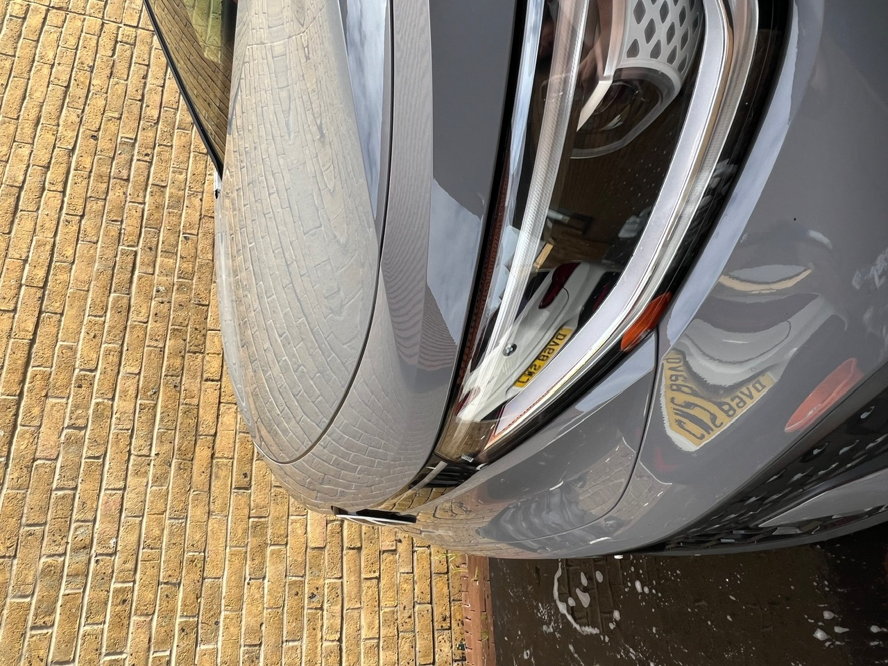 Water beading off a freshly protected Volkswagen ID.5 bonnet and headlight